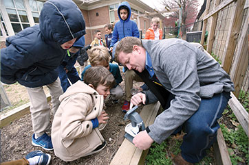 Photo of an instructor showing students how to use a saw. Link to Donor-Advised Funds