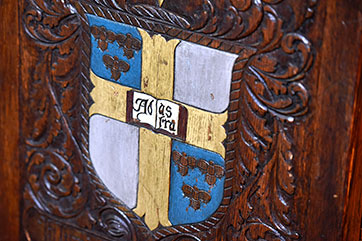 The school seal on woodwork. Link to Tangible Personal Property